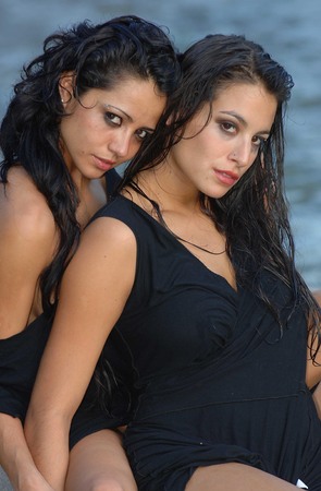 Two gorgeous women wearing a black dressの写真素材