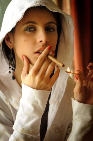 Cute young brunette woman with a cigaretteの写真素材