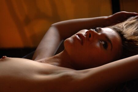 Gorgeous young naked blonde girl on the tableの写真素材