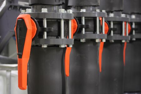 Several water regulating valves with orange clipsの写真素材