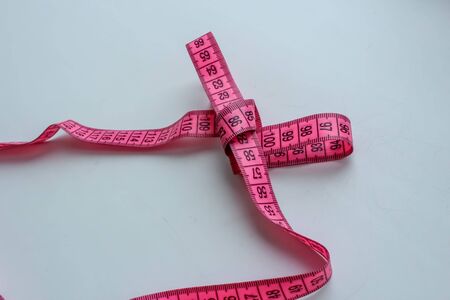 Bunch of measuring tape on white background