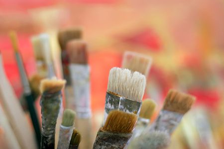 paint brushes against colored backgroundの写真素材
