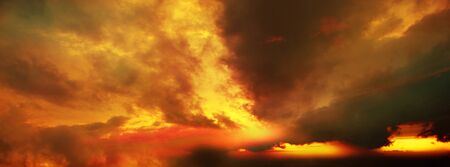 Dramatic sunset sky with tinted, colored clouds in summer season. Banner, Background,...
