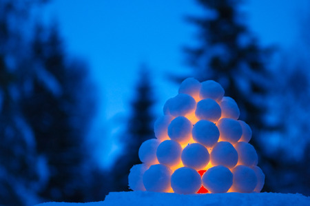 Snowball lantern in winter landscape at dusk.の写真素材