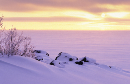Sunset over frozen lake in winter.の写真素材