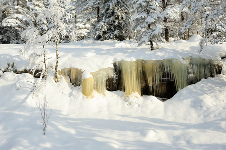 Icicles hanging from a rock cliff. Snowy landscape in Koli National park, Finlandの写真素材