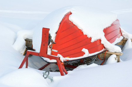 Boat upside down covered with snowの写真素材