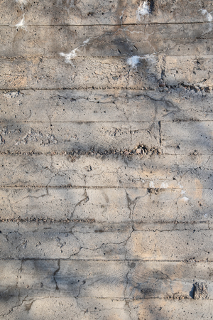 Old cracked and weathered concrete wallの写真素材