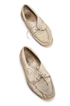 A pair of old walking shoes on white background.の写真素材