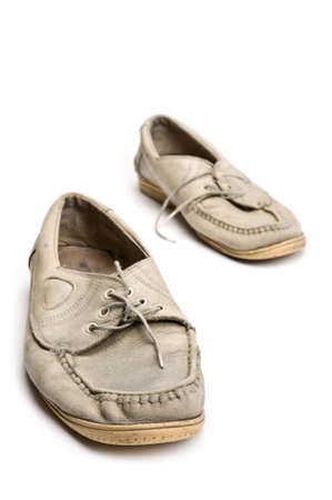 A pair of old walking shoes on white background.の写真素材