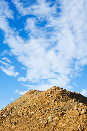 Heap of sand and gravel against sky.の写真素材