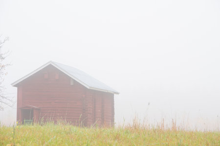 Barn in foggy autumn landscapeの写真素材