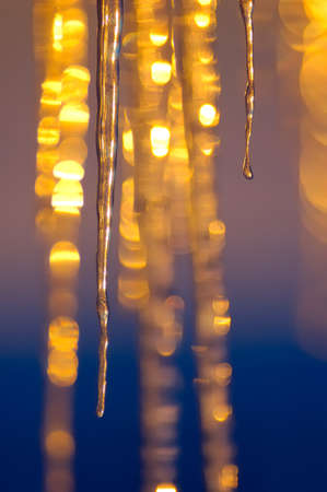 The setting arctic sun illuminates the iciclesの写真素材