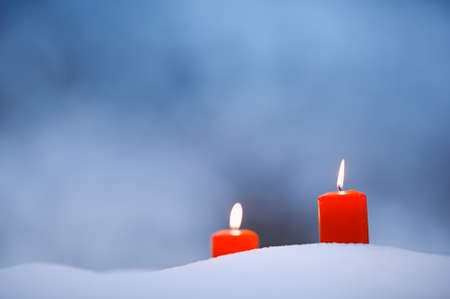 Candles in the snowの写真素材