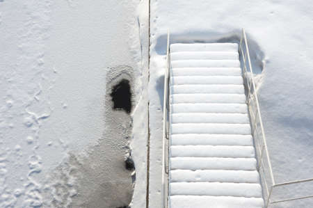 Stairs covered with fresh snowの写真素材
