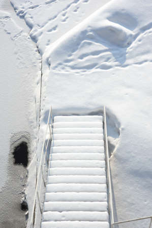 Stairs covered with fresh snowの写真素材