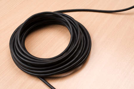 Electric cable on wooden tableの写真素材