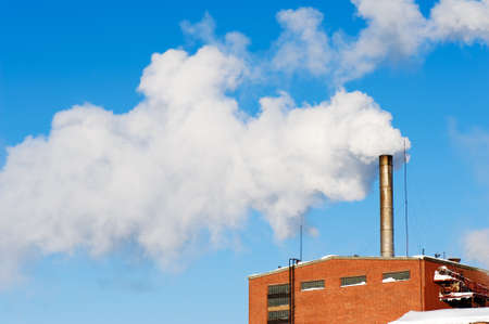 Exhaust fumes blown into a blue sky.の写真素材