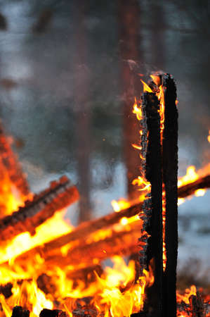 Close-up of the remains of a burning house.