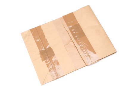 Taped paper envelope on white background.