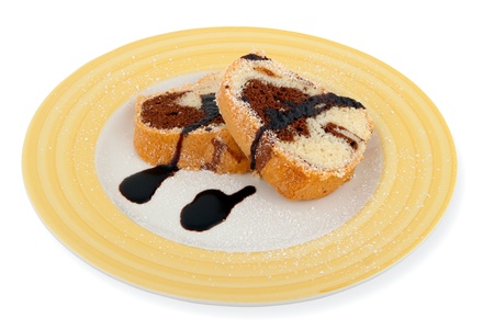 Home made Marble Cake Slices on plate with topping isolated on whiteの写真素材