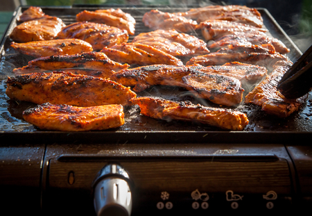 Tasty chicken steaks on the contact electric grill - closeup picture. Healthier grilling.の写真素材
