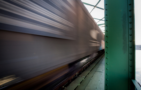 Close up picture of freight train in motion on bridgeの写真素材