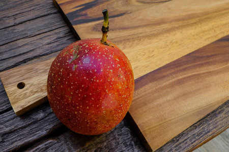 Whole passion fruit on wooden board