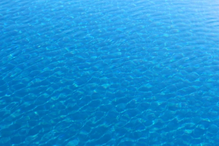 Blue clear water of a pool, on a sunny dayの写真素材