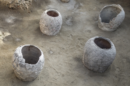 old clay pot excavations into ancient city ruins under sunlightの写真素材
