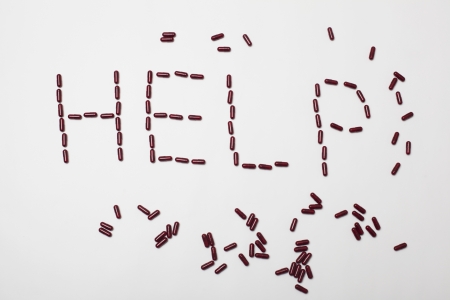 Word help created by pills on white background in studioの写真素材