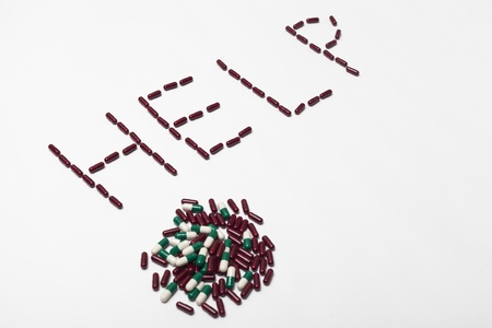 Word help created by pills on white background in studioの写真素材