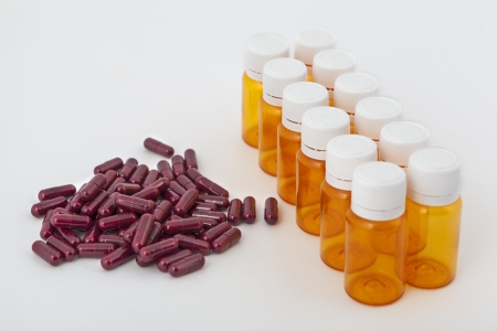 Pills and bottles on white background in studioの写真素材