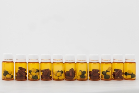 Pills in bottles on white background in studioの写真素材