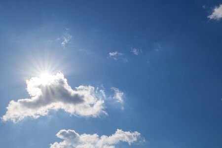 The sun shining through the cloudsの写真素材