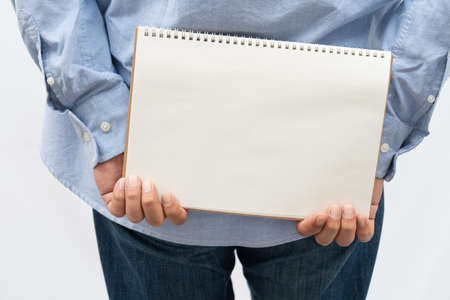 a middle-aged man in casual wear with a sign boardの写真素材