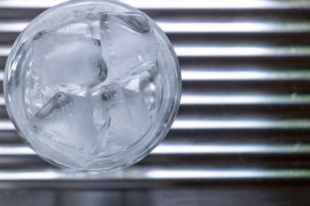 a glass of cold water with iceの写真素材