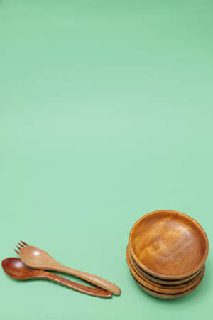 wooden tableware placed on a green backgroundの写真素材