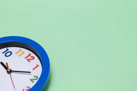 Colorful clock in green background