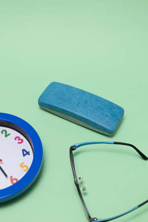 Green background clock, glasses and glasses case