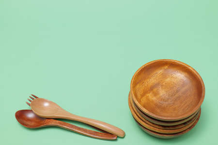 wooden tableware placed on a green backgroundの写真素材