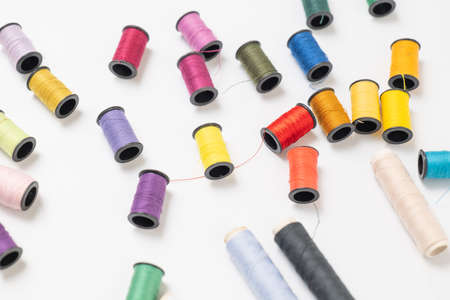 Colorful sewing thread placed on a white back