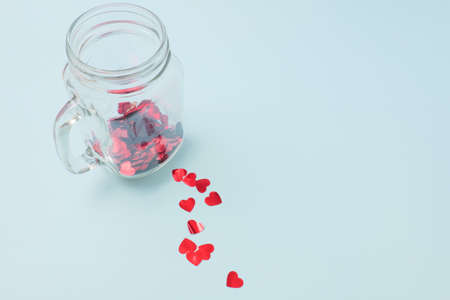 Numerous red hearts with glass bottles with blue backgroundsの写真素材