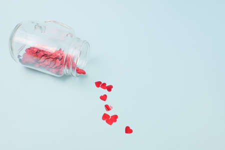 Numerous red hearts with glass bottles with blue backgroundsの写真素材
