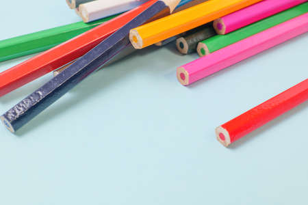Colorful colored pencils on a blue background