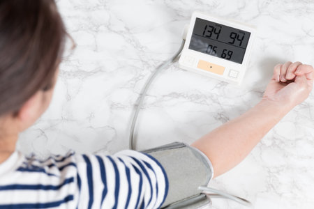 Middle-old woman measuring blood pressureの写真素材