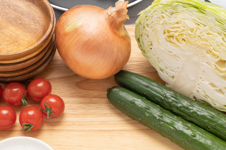 Cooking utensils and ingredients spread in the kitchenの写真素材