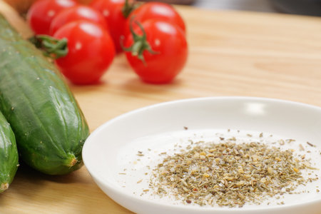 Ingredients and herbal salts placed on cutting boardsの写真素材