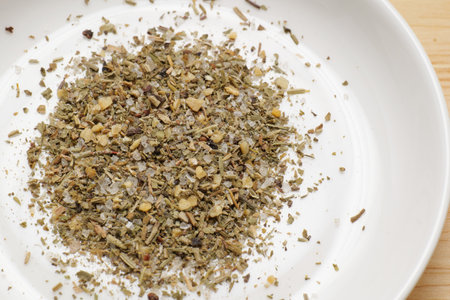 herb salt on a white plateの写真素材
