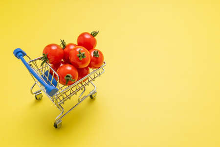 Cutting board with lots of petit tomatoesの写真素材